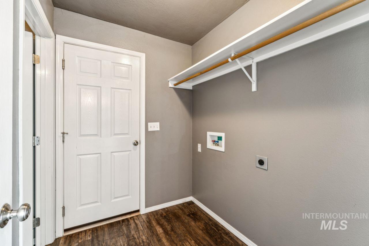 5410 Barkley Way Caldwell, ID 83607 - Photo 37 of 50 Laundry room featuring dark wood-style flooring, hookup for a washing machine, and electric dryer hookup