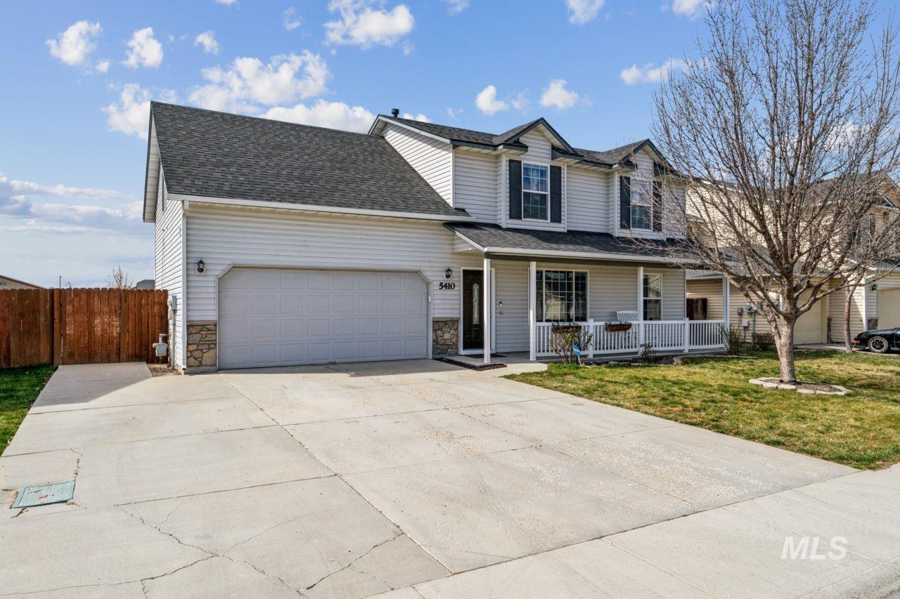5410 Barkley Way Caldwell, ID 83607 - Photo 4 of 50 Traditional-style home featuring covered porch, an attached garage, concrete driveway, roof with shingles, and stone siding