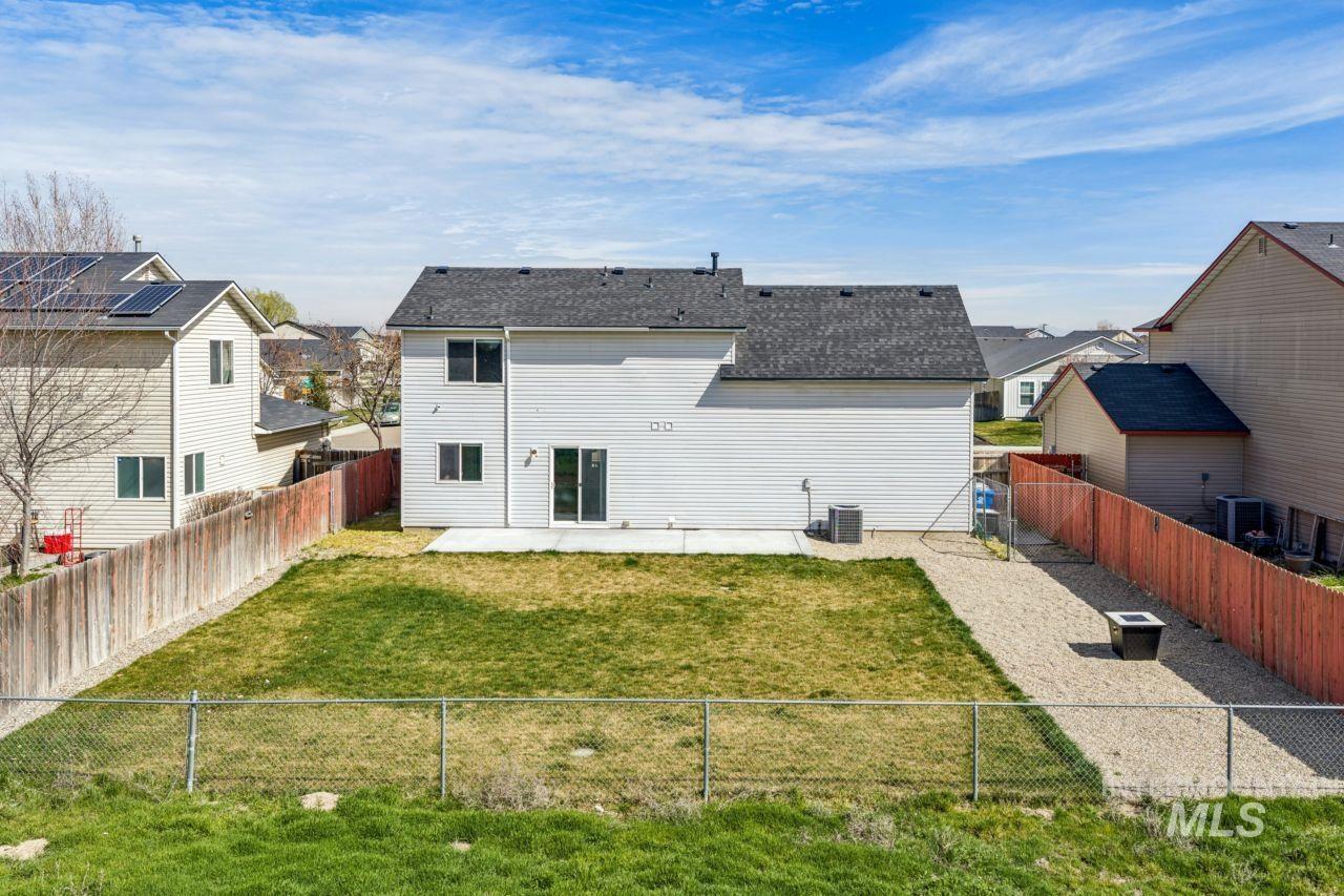 5410 Barkley Way Caldwell, ID 83607 - Photo 47 of 50 Back of property with a patio, a residential view, and a fenced backyard
