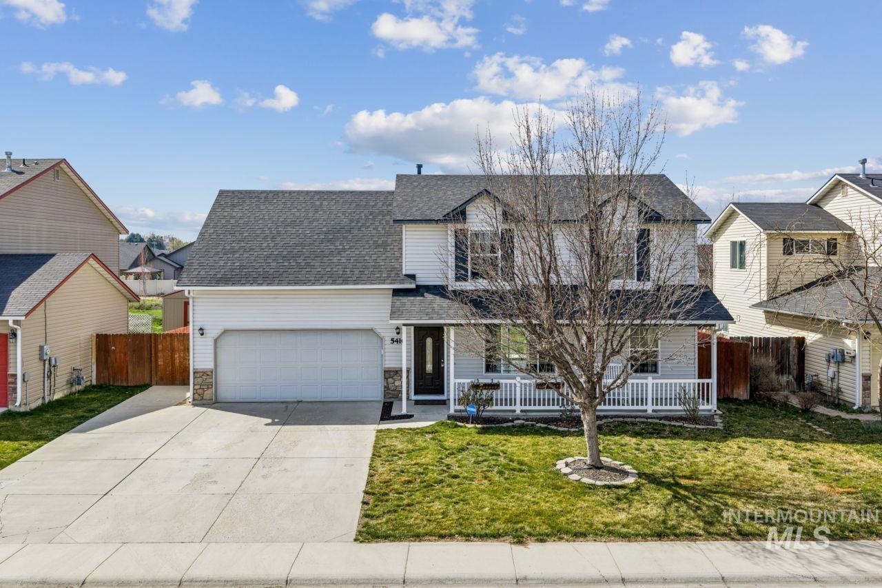 5410 Barkley Way Caldwell, ID 83607 - Photo 48 of 50 Traditional-style home featuring driveway, a shingled roof, stone siding, a porch, and an attached garage