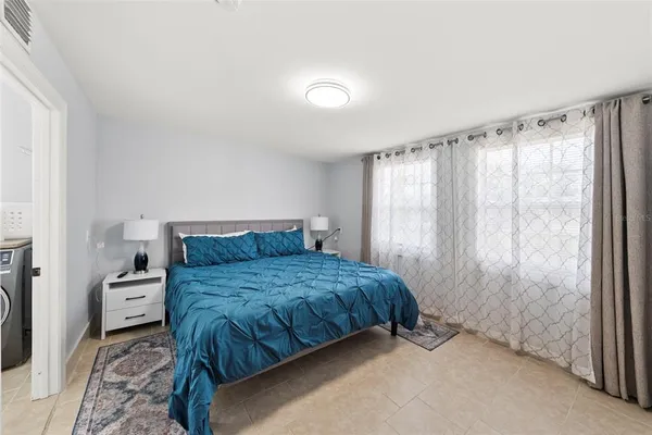 a bedroom with a bed and a couch