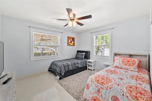a bedroom with a bed a dresser and a window