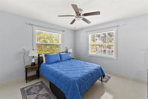 a bedroom with a large bed and a chandelier
