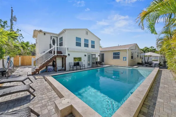 a view of swimming pool with outdoor seating