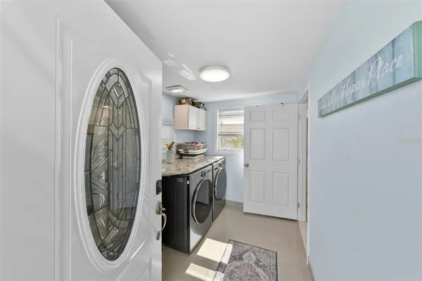 a bathroom with a granite countertop sink a toilet and shower