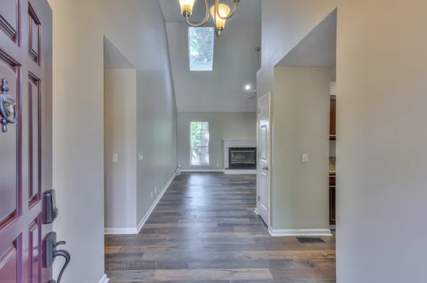 a view of a hallway with wooden floor and staircase