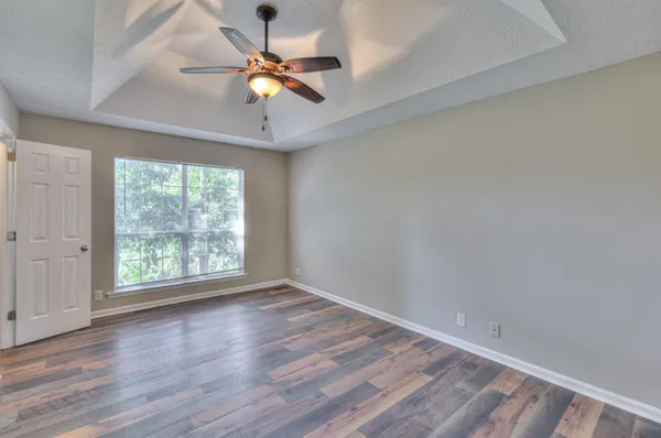 wooden floor in an empty room with a window