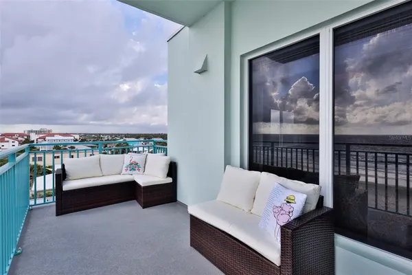 a balcony with table and chairs