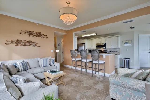 a kitchen with stainless steel appliances granite countertop a sink refrigerator and microwave