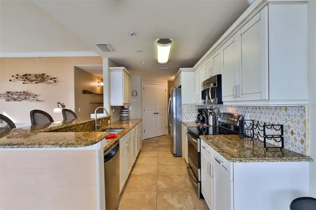 a kitchen with stainless steel appliances a refrigerator stove and sink