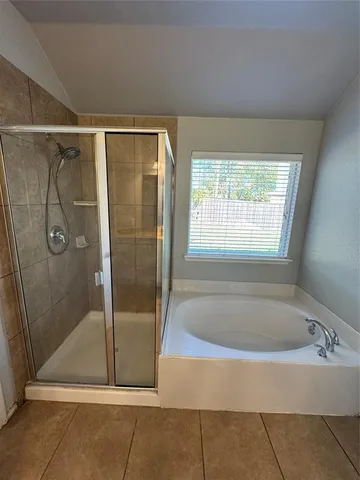 a bathroom with a bathtub and shower