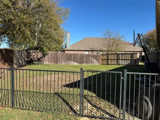 a view of swimming pool with a yard and sitting area