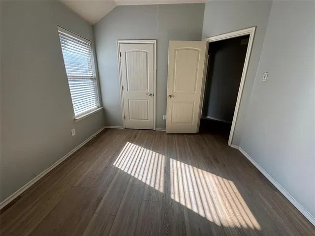 an entryway with wooden floor and closet