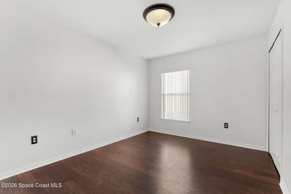 a view of a kitchen with wooden floor and a ceiling fan