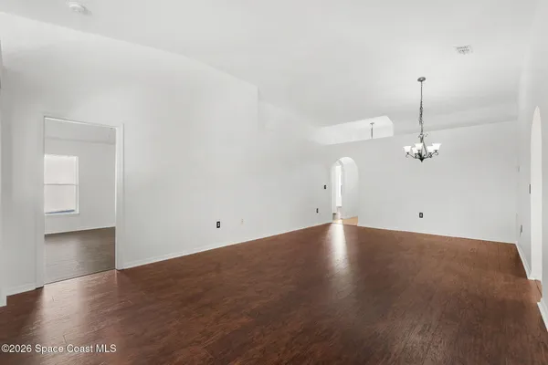 a view of an empty room with a ceiling fan