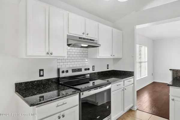 a kitchen with stainless steel appliances a sink stove and cabinets