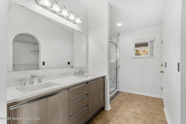 a view of an empty room with a floor to ceiling window and an outdoor view