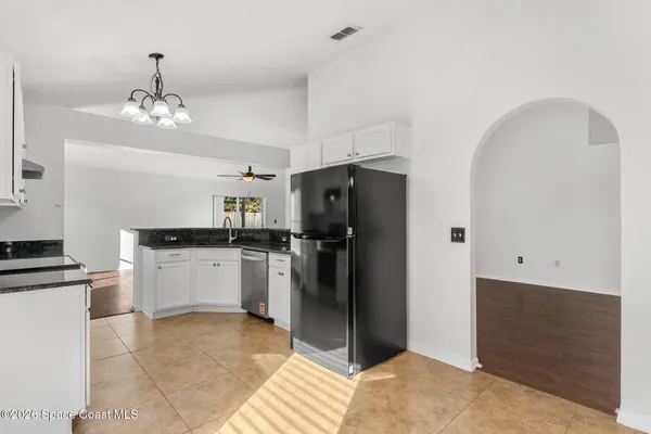 a kitchen with granite countertop stainless steel appliances a stove a sink and a refrigerator