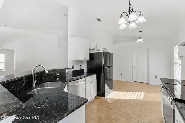 a kitchen with stainless steel appliances a sink and a refrigerator