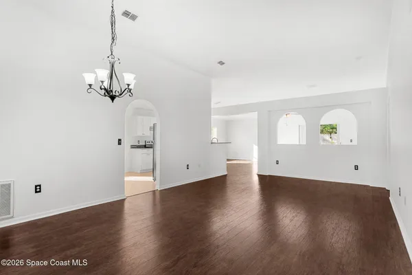 a view of a room with wooden floor and carpet