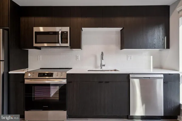 a kitchen with a sink and a microwave