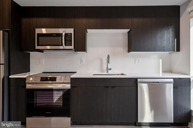 a kitchen with a sink and a microwave