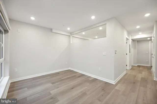 a view of an empty room with wooden floor