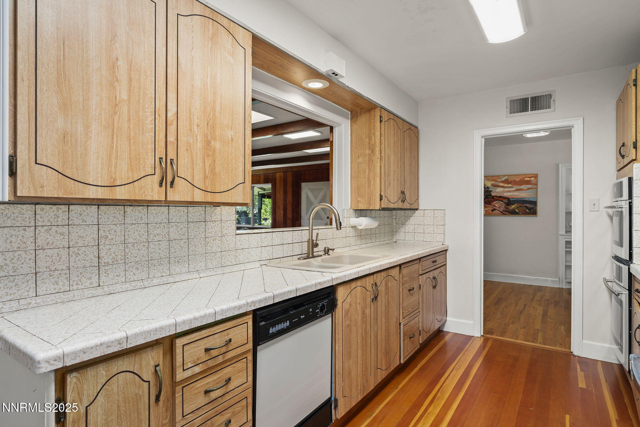 2330 Sunrise Drive Reno, NV 89509 - Photo 25 of 48 a kitchen with a sink and a wooden cabinets