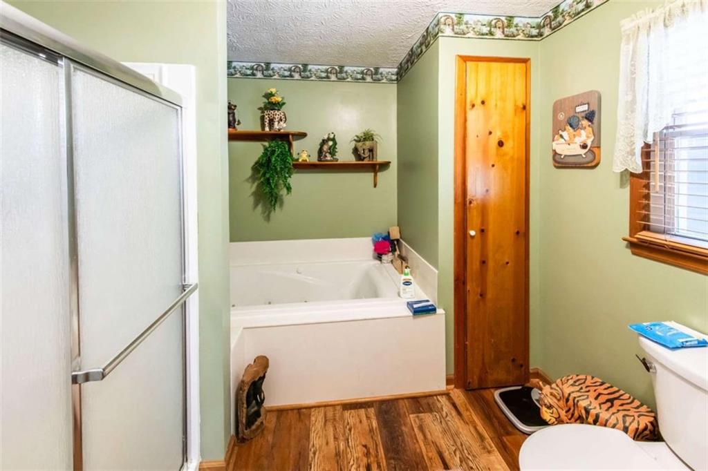 261 Clayton Trail Canton, GA 30114 - Photo 12 of 37 a bathroom with a bathtub and shower