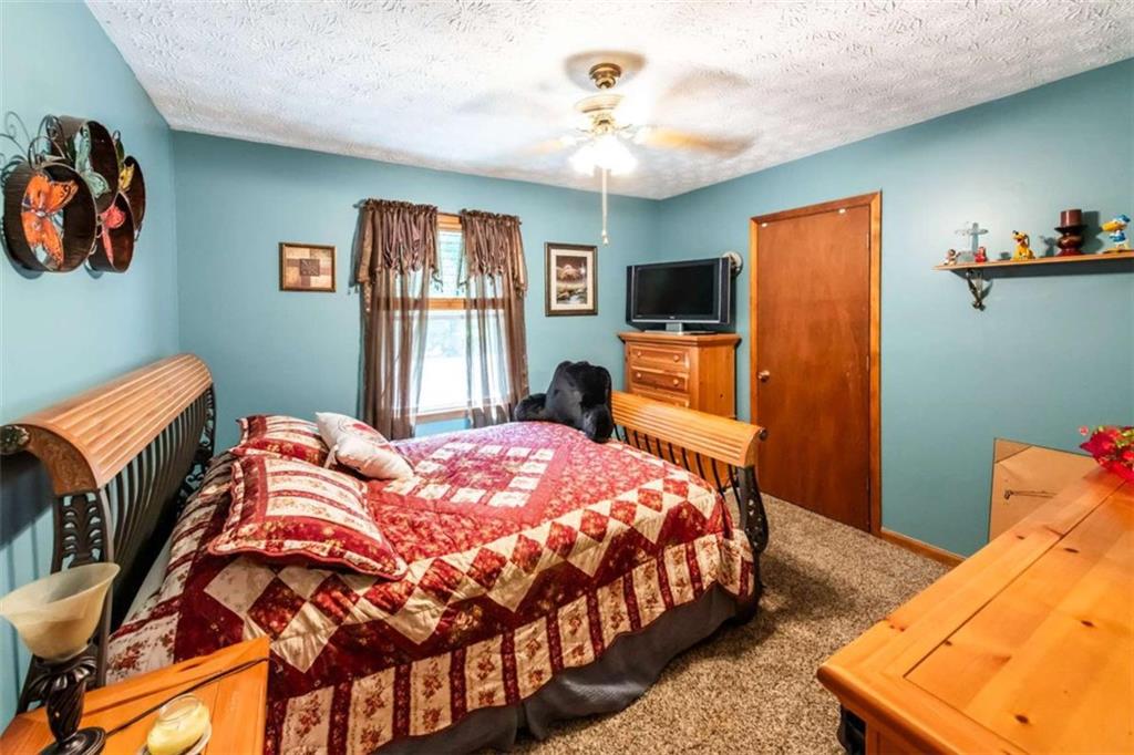 261 Clayton Trail Canton, GA 30114 - Photo 14 of 37 a bedroom with bed and wooden floor