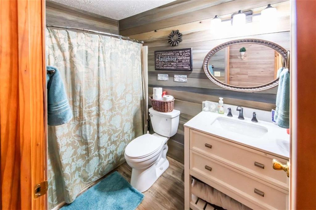 261 Clayton Trail Canton, GA 30114 - Photo 15 of 37 a bathroom with a toilet a sink and a mirror