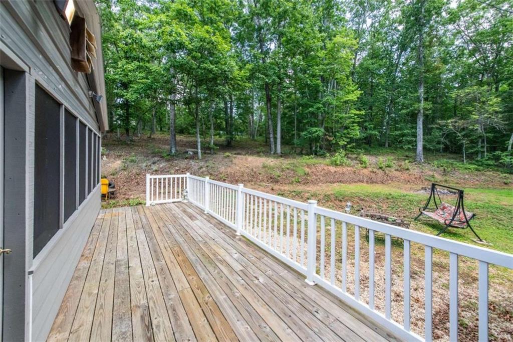261 Clayton Trail Canton, GA 30114 - Photo 20 of 37 a view of backyard with a deck and wooden floor