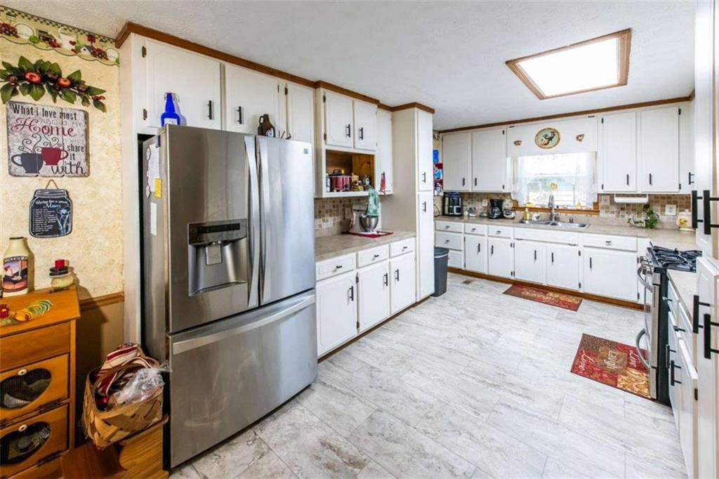 261 Clayton Trail Canton, GA 30114 - Photo 4 of 37 a kitchen with stainless steel appliances a refrigerator sink and cabinets