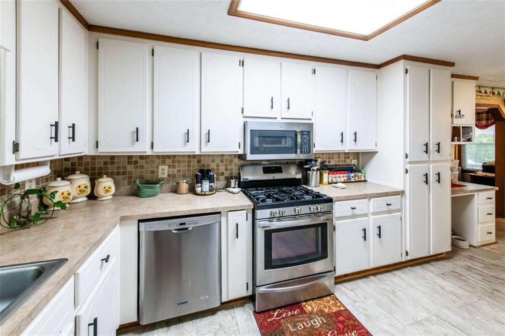 261 Clayton Trail Canton, GA 30114 - Photo 5 of 37 a kitchen with appliances a sink and cabinets