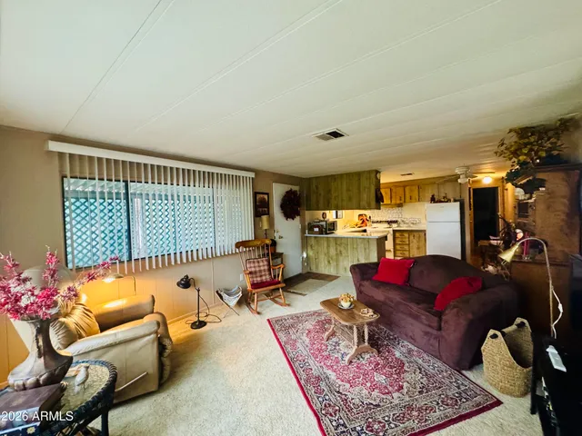 a living room with furniture rug and a window