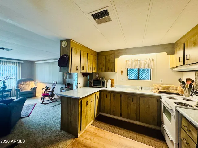 a kitchen with a sink and a stove top oven