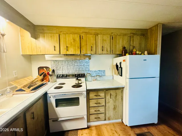 a kitchen with a stove a refrigerator and a sink