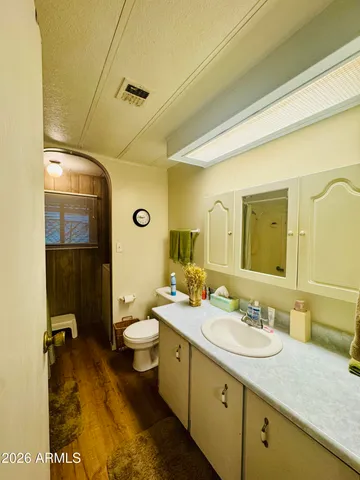 a bathroom with a double vanity sink mirror and toilet