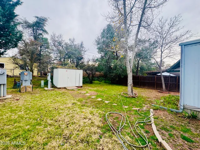a backyard of a house with yard and outdoor seating