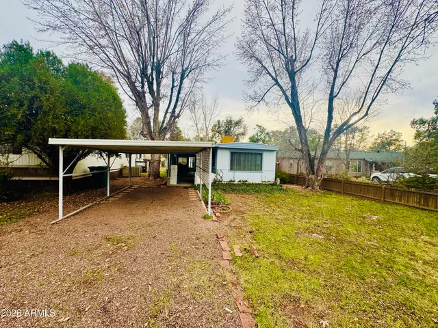 a view of a house with backyard porch and sitting area
