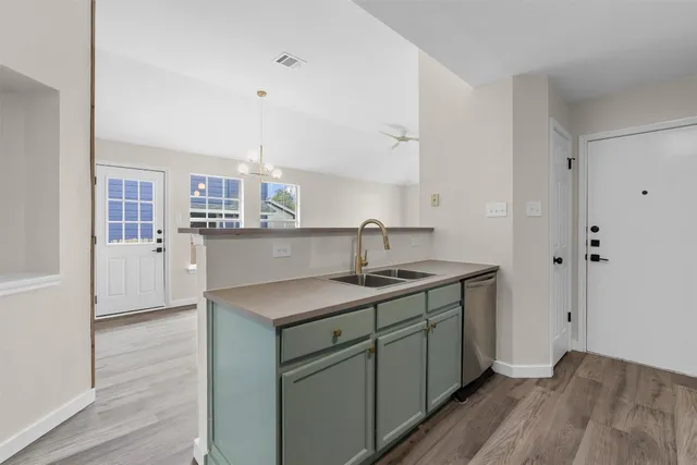 a kitchen with stainless steel appliances a sink stove and cabinets