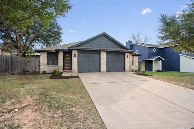 a front view of a house with a yard and garage