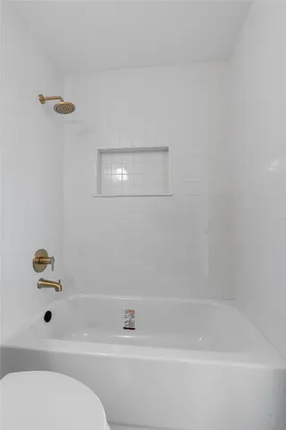 a bedroom with a large bed and a potted plant