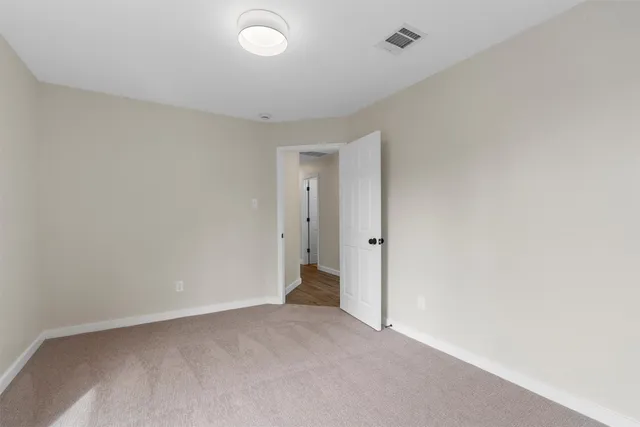 a view of a house with backyard and wooden fence