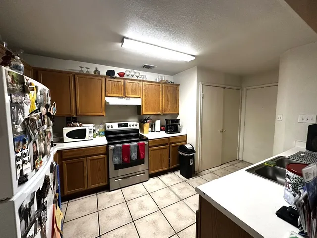 a bedroom with bed and a flat tv screen