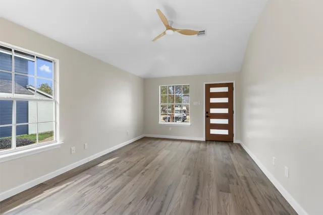 an empty room with windows and closet