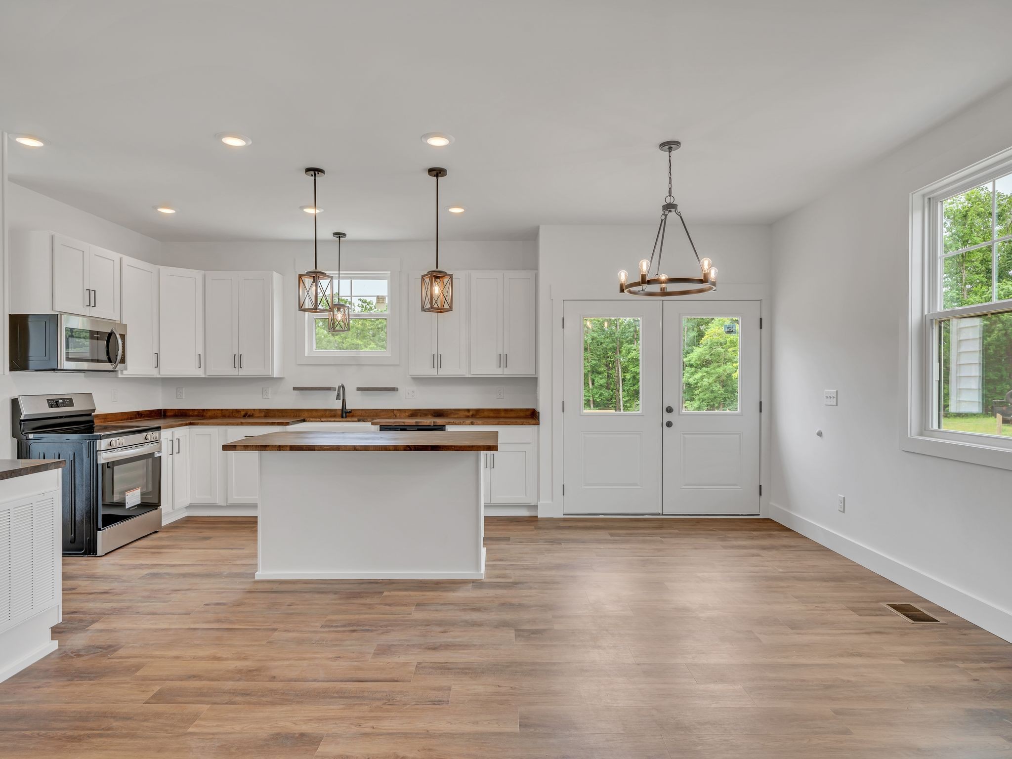 5800 Sanders Road Lyles, TN 37098 - Photo 7 of 28 a large kitchen with kitchen island a large counter top space a sink stainless steel appliances and cabinets