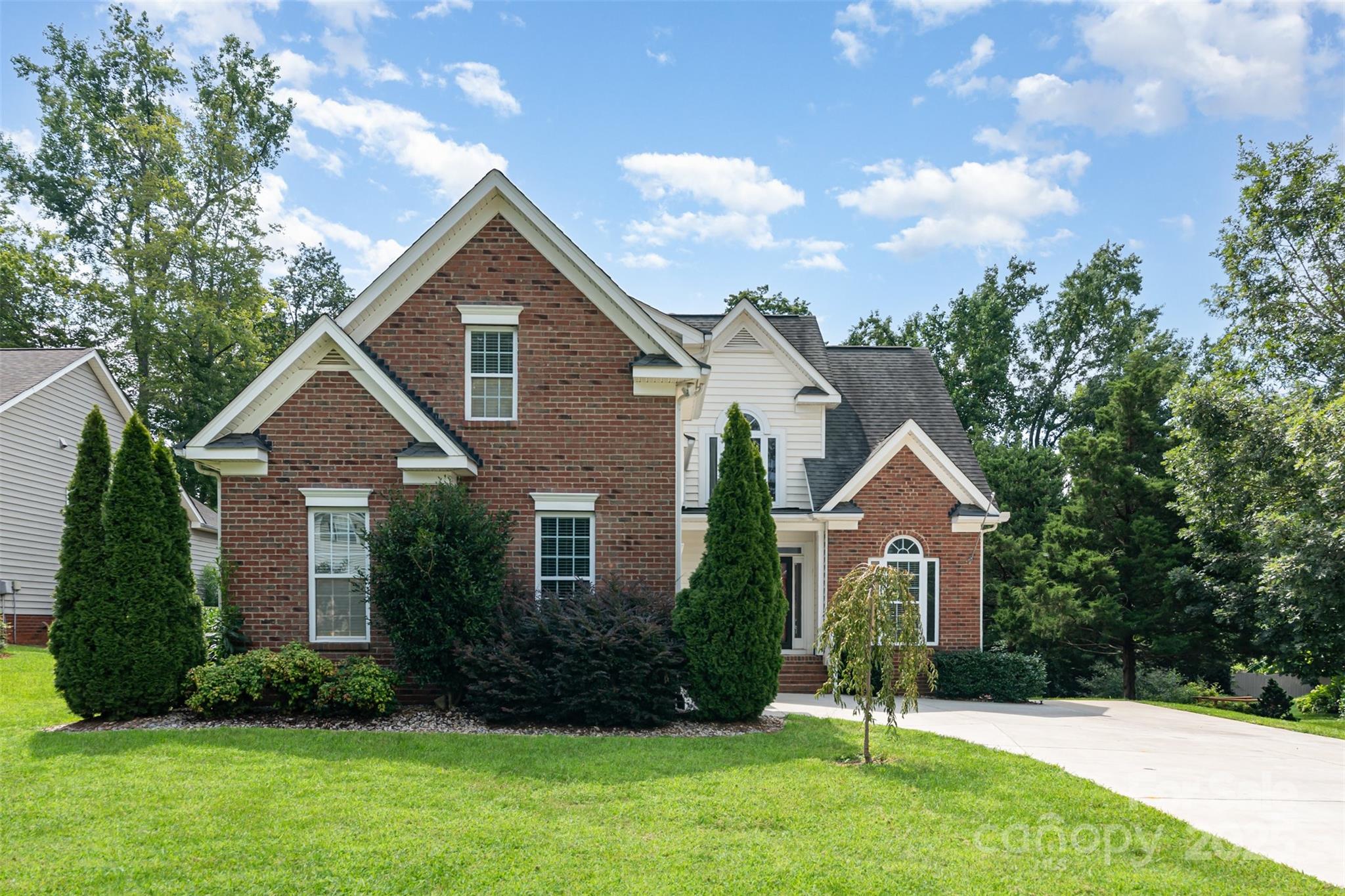 2746 Cameron Commons Way Matthews, NC 28104 - Photo 1 of 38 a front view of a house with a yard and garage