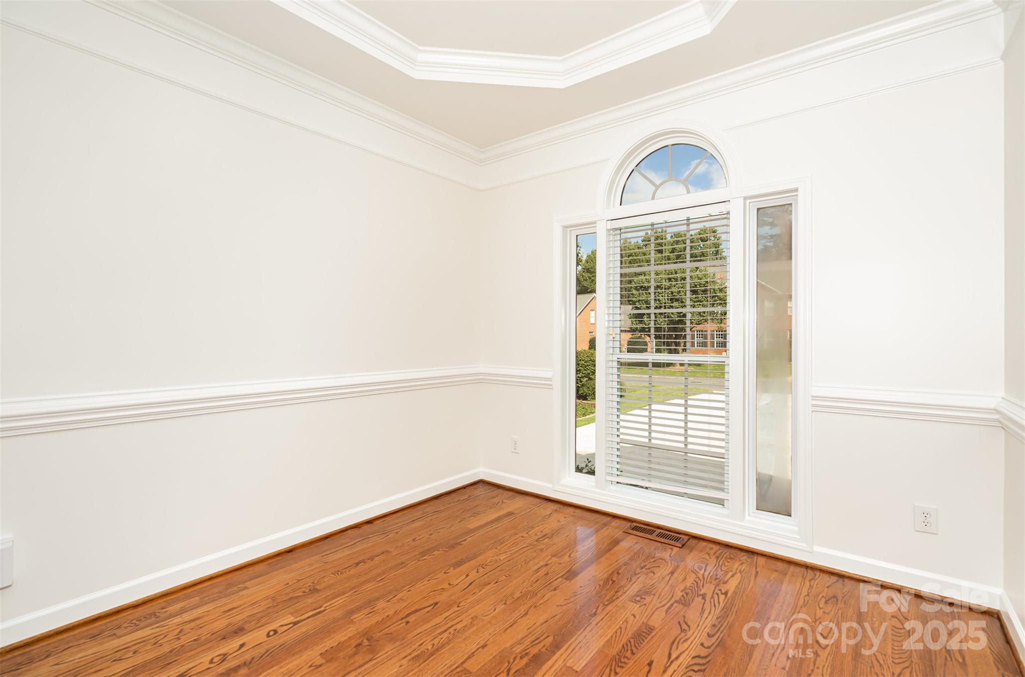 2746 Cameron Commons Way Matthews, NC 28104 - Photo 11 of 38 a view of an empty room with wooden floor and a window