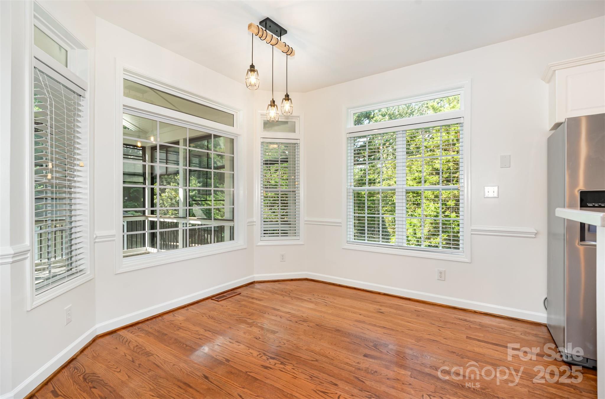 2746 Cameron Commons Way Matthews, NC 28104 - Photo 12 of 38 a view of an empty room with a window and wooden floor